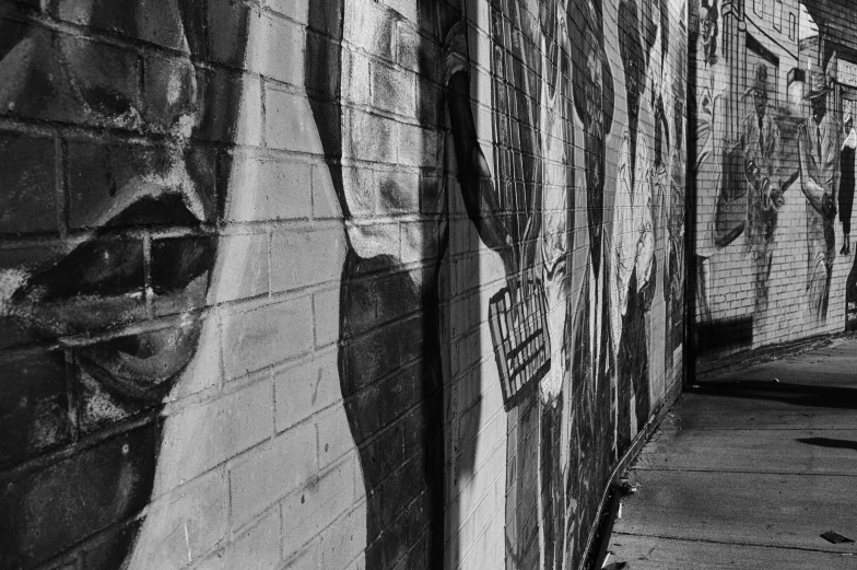 a person walking past a wall covered in graffiti