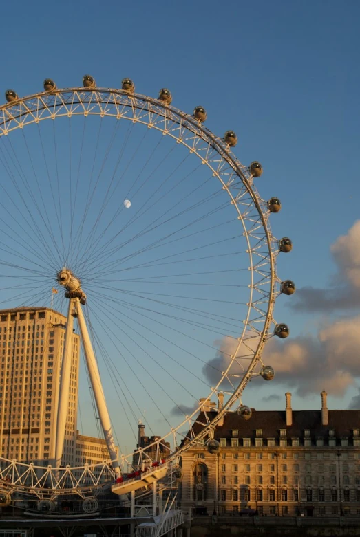 a ferris wheel in front of a tall building