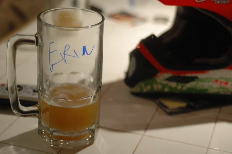 a glass of beer sitting on top of a white table