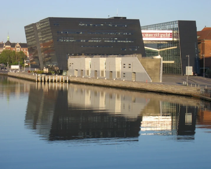 a body of water sitting next to a long building