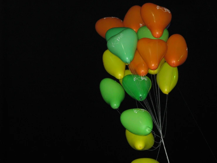 a bunch of balloons are in the dark