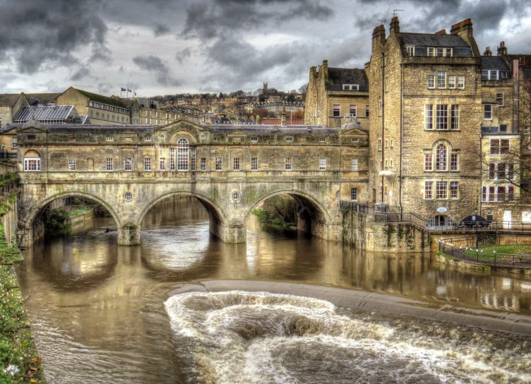 a waterway in an old european country with a bridge