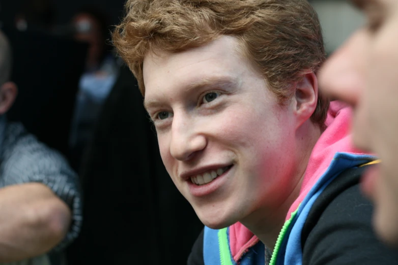 a young man smiles at the camera