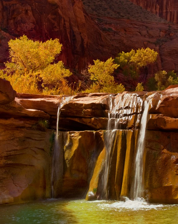 a waterfall with water is flowing from it