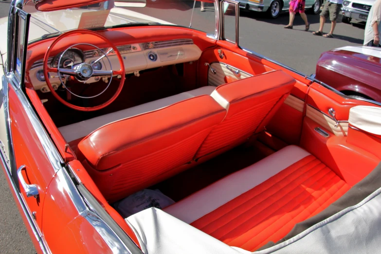the interior of an orange classic sports car