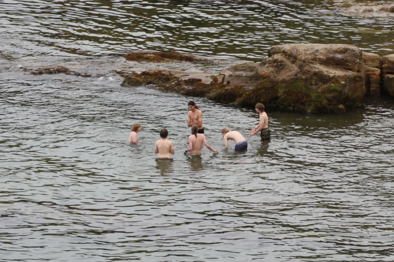a group of young men playing in the water
