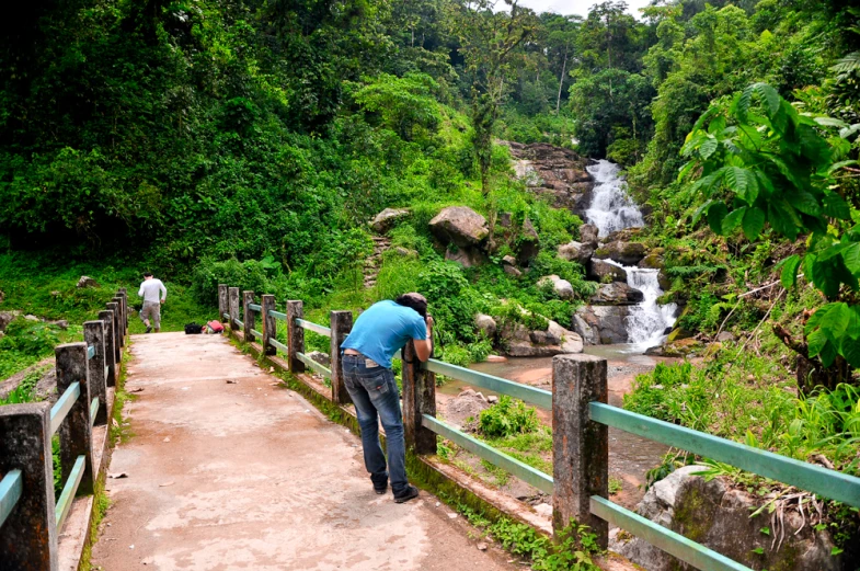 a person on a path next to a stream