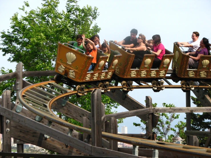 children ride on a roller coaster at a park