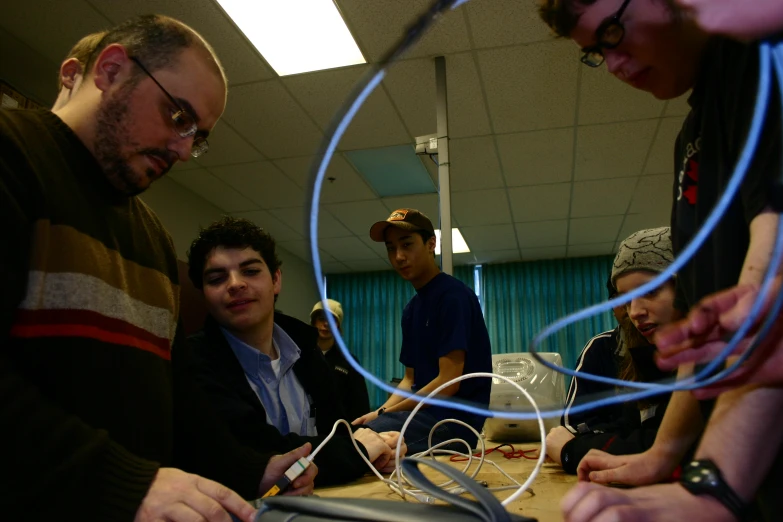 a group of people looking at a device