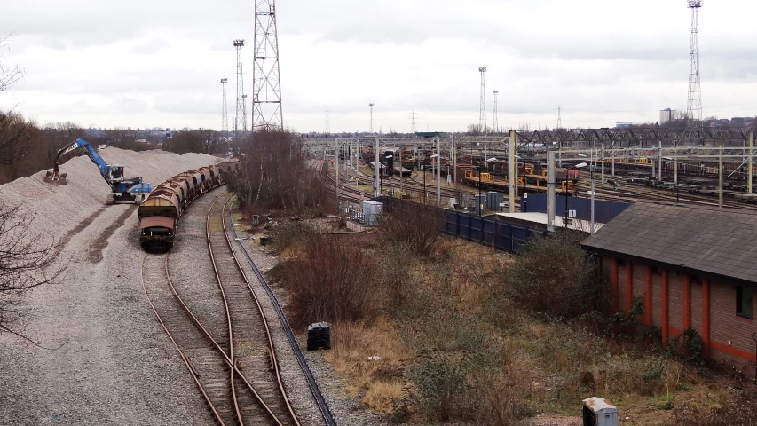 a train traveling down train tracks next to tall buildings