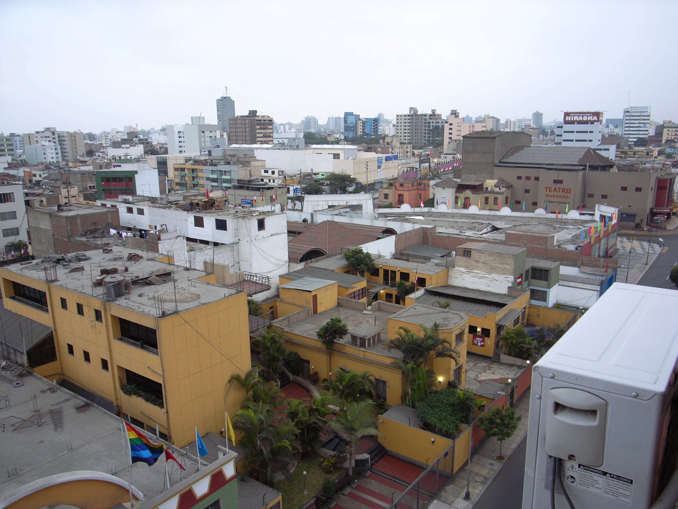 a bunch of buildings on a hill overlooking some very tall buildings