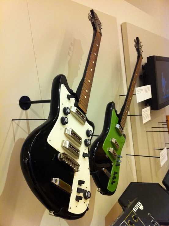 guitars and a guitar are being displayed in a room