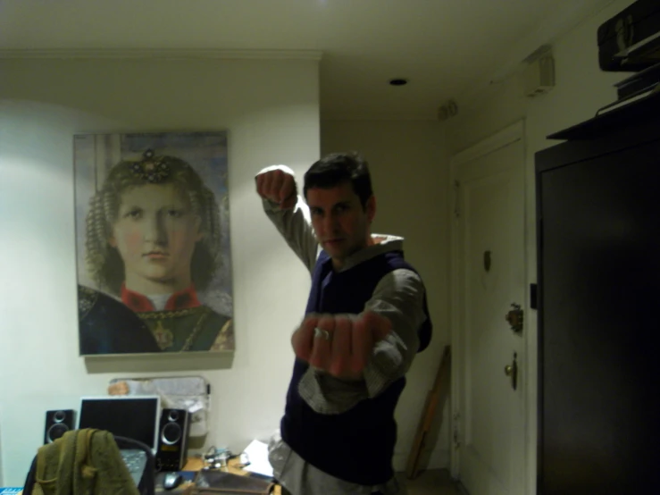 a man is pointing a gun in a kitchen