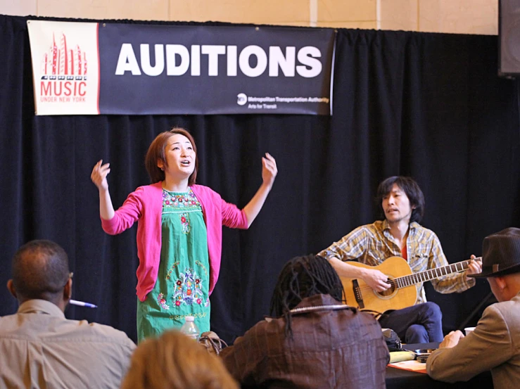 a woman on stage giving a talk to a crowd