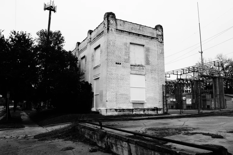 a building on the street corner with wire and poles