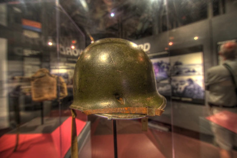 an army helmet with several other objects behind it