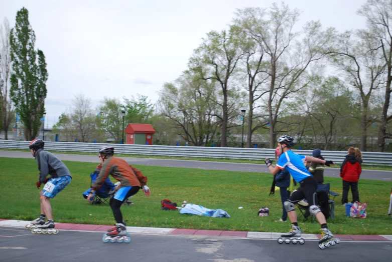 skateboarders on roadway in open area of park