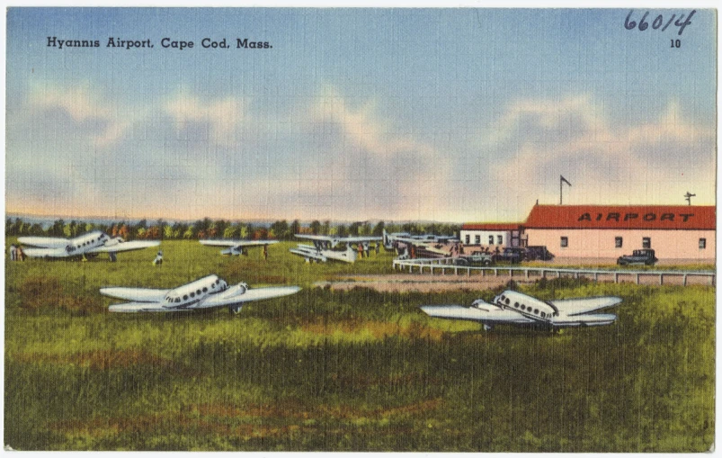 a picture from an early era of a town with planes parked outside