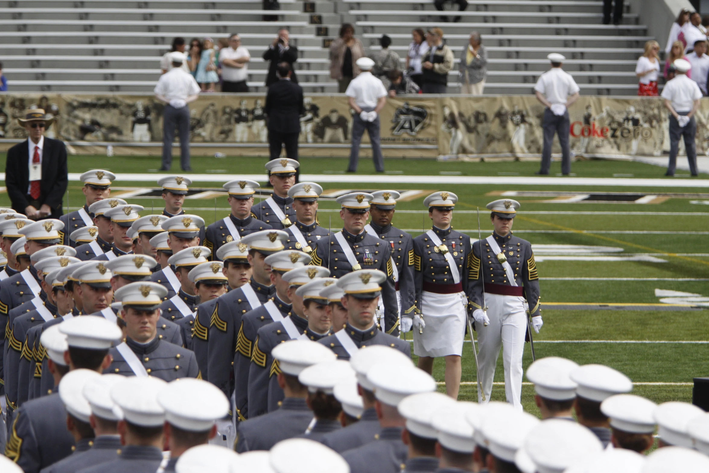 military men on a field with people standing around