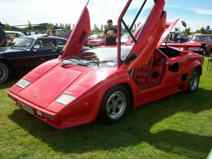 this is a red car in front of other cars