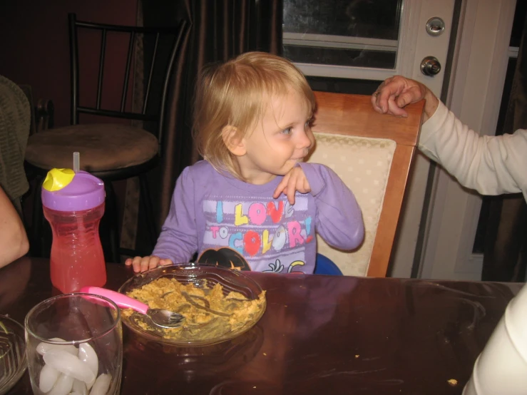 a girl is sitting in front of some food