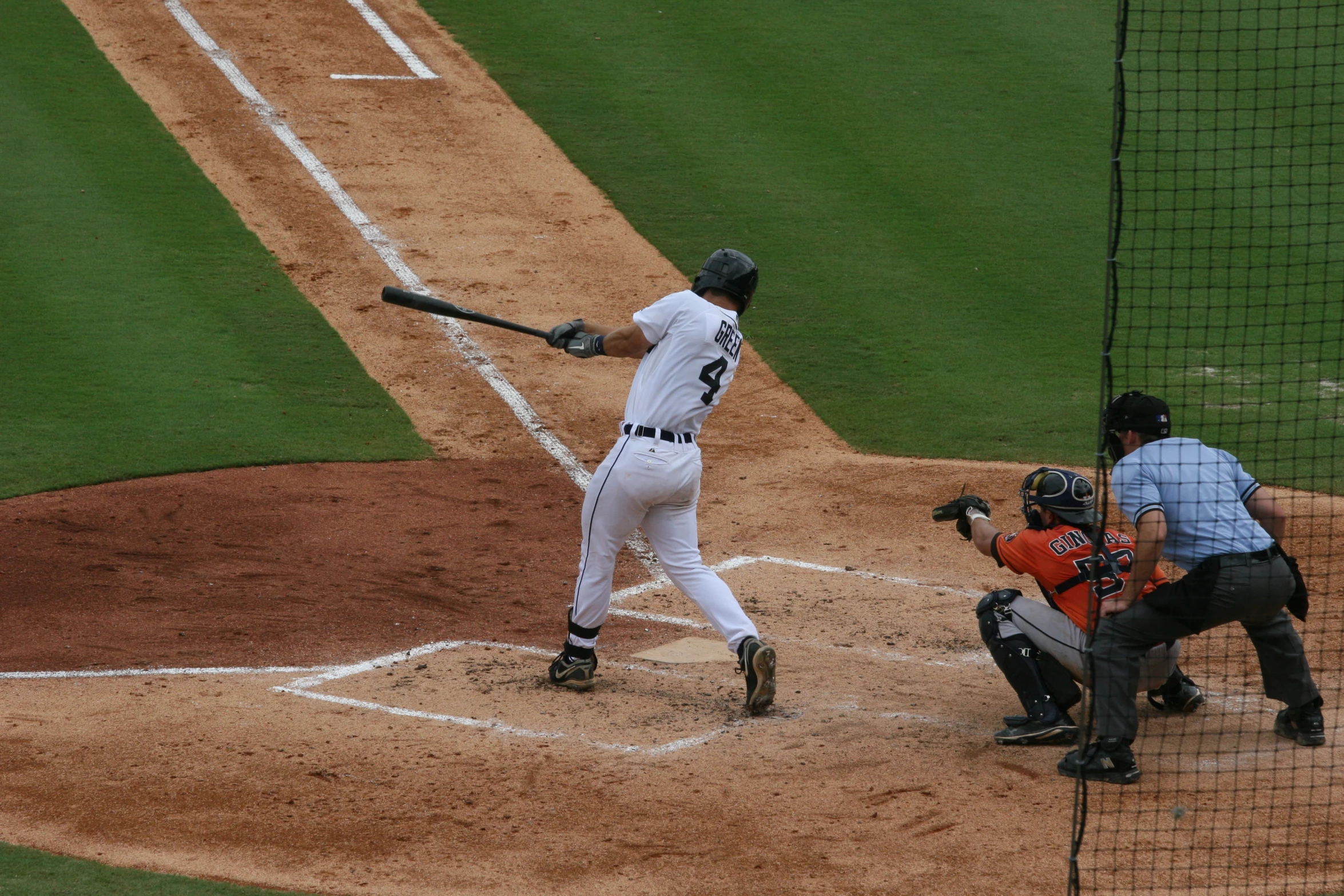 professional baseball player holding his bat up and ready to hit a ball