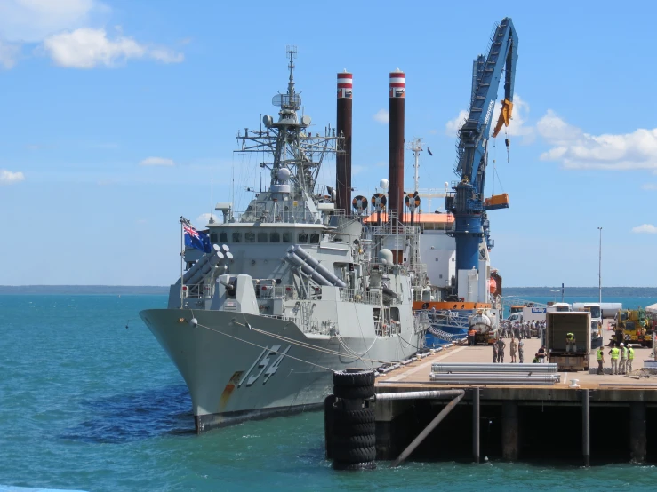 a large boat docked in the water next to a dock