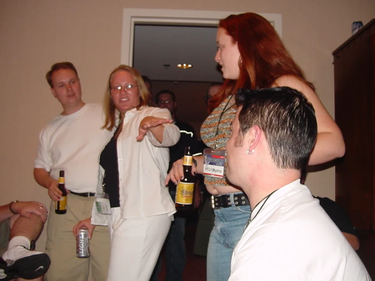 group of people standing in front of a door holding drinks