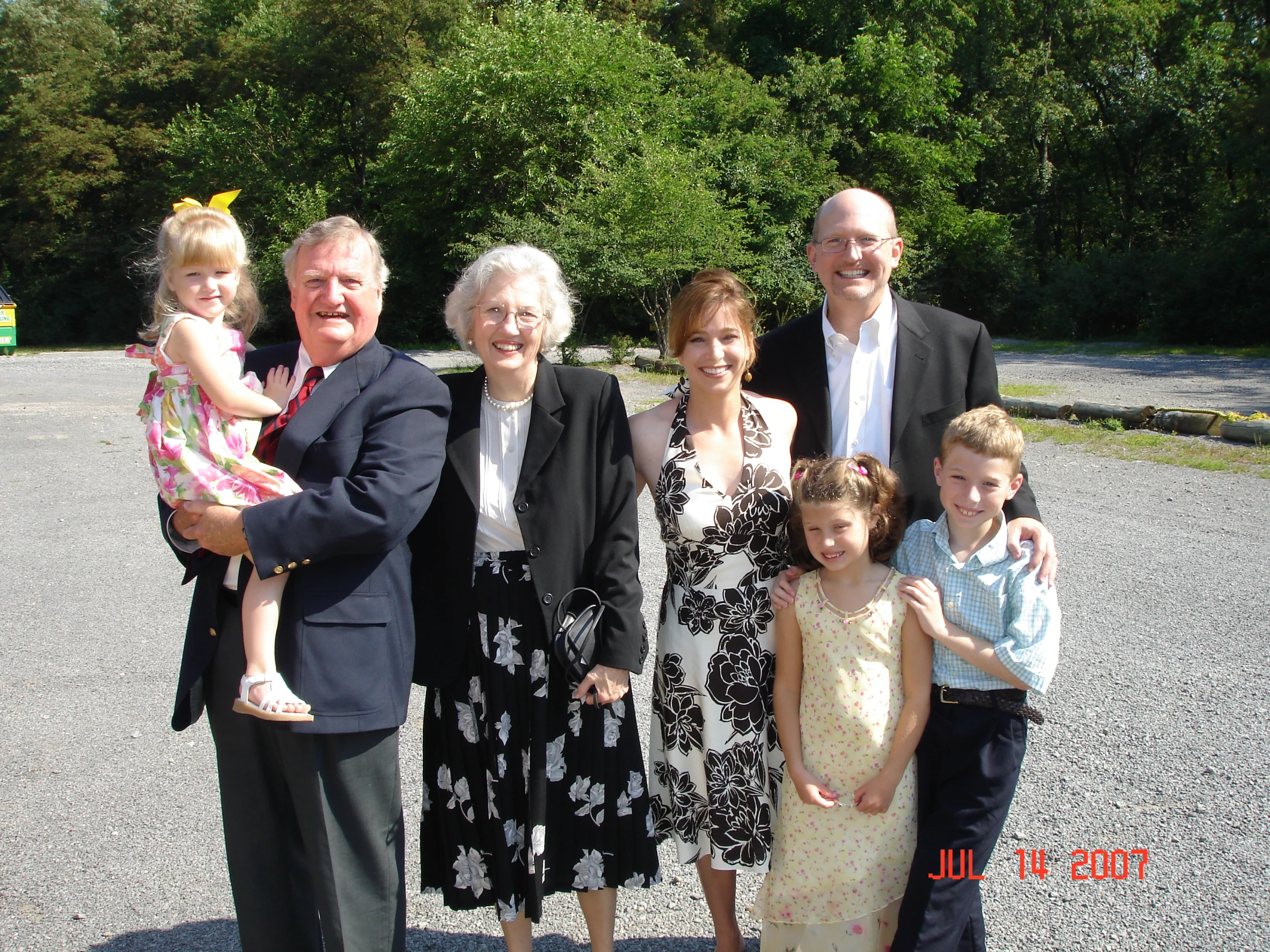 a man and two women and two children posing for a picture