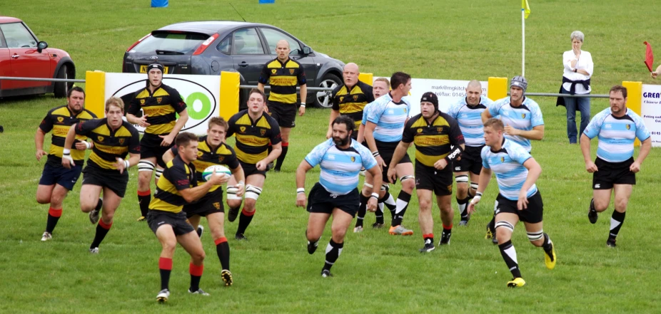 the rugby team runs through a field