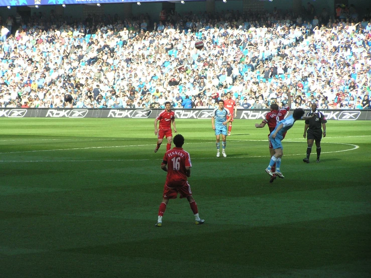 a man in white shorts kicking a soccer ball on a field