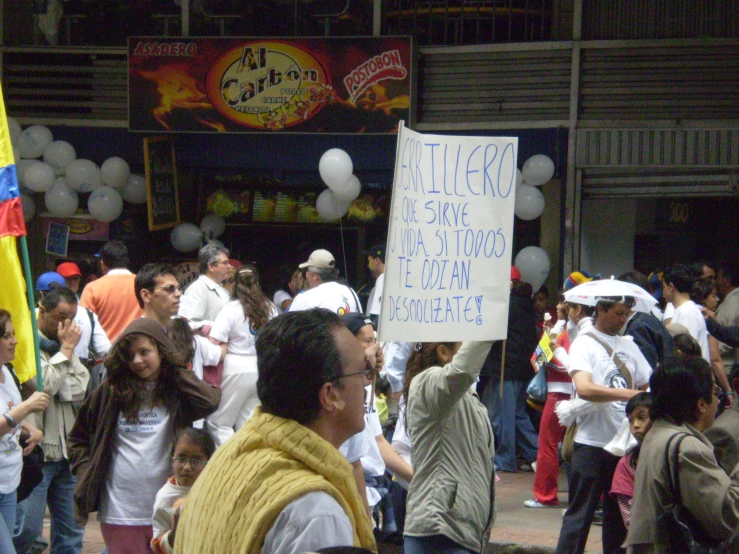 people gather at a rally protesting on the street