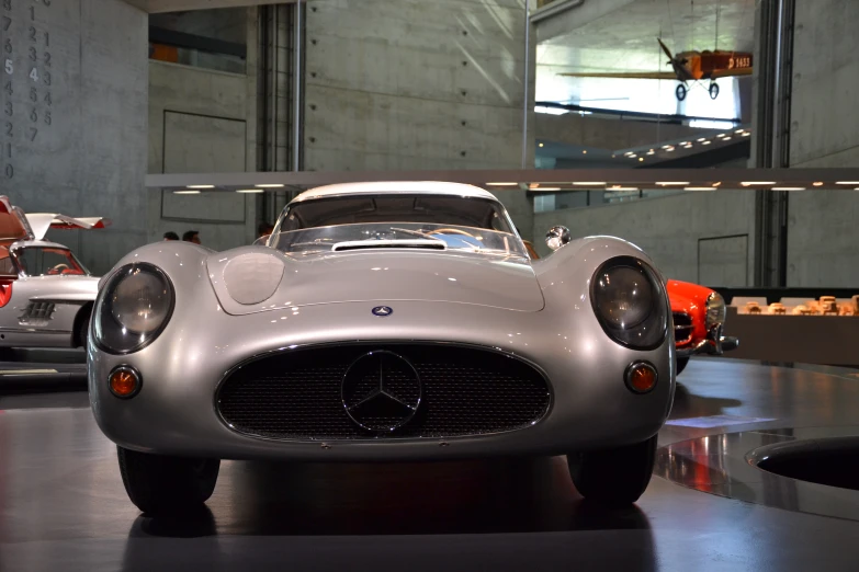 a silver sports car sitting in the middle of a building