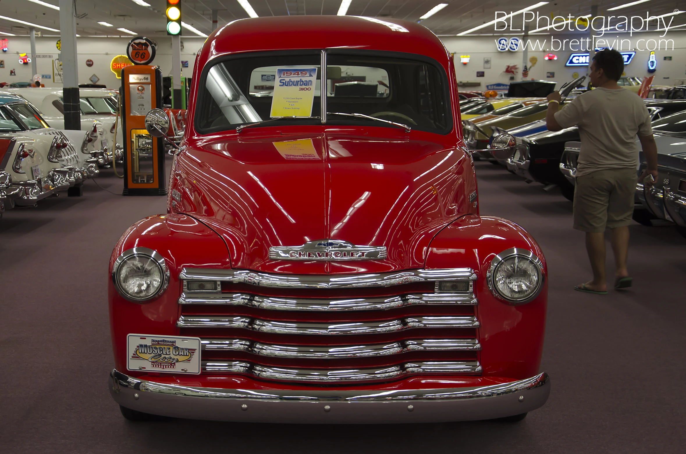 an old, red, truck is parked in a garage