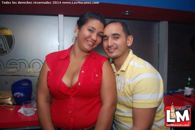 two young people standing together in front of counter top