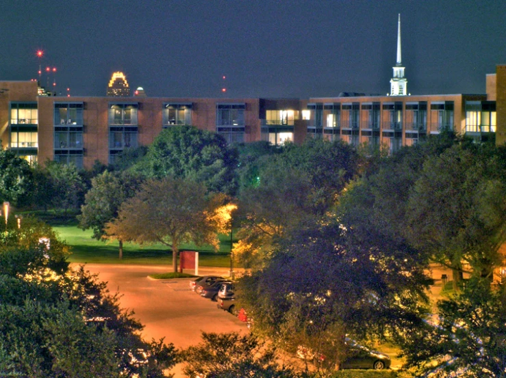 a very large building in the distance with a green field in front of it