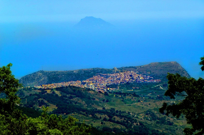 view from a mountain looking at the town in the distance