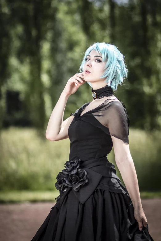 a person wearing a black dress and blue hair