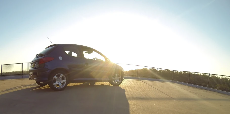 the sun shines on a vehicle driving on the highway