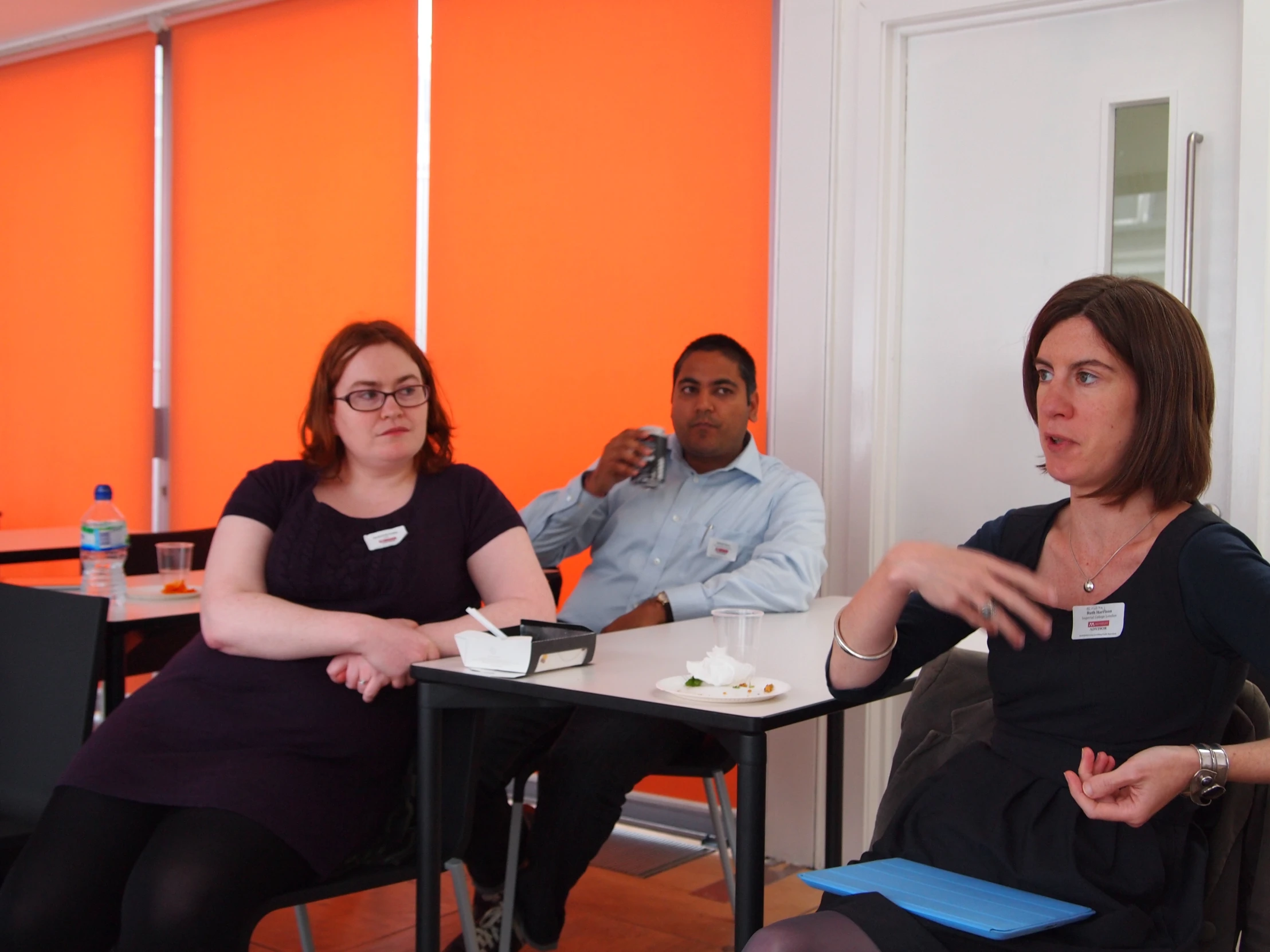 four people sitting in chairs at a table