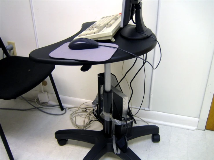 a chair and desk computer sit on wheels