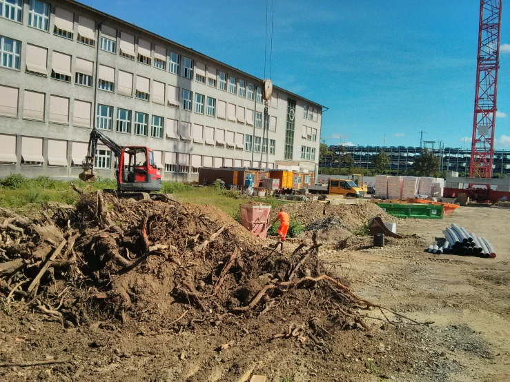 workers stand near the pile of sand that has been piled