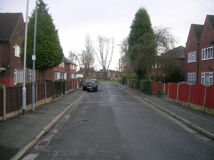 a car is parked on the side of a residential street