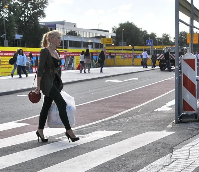 a woman is walking on the street with bags