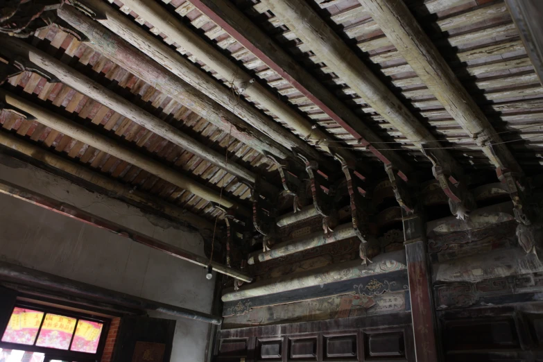 the roof of an old building is worn and stained