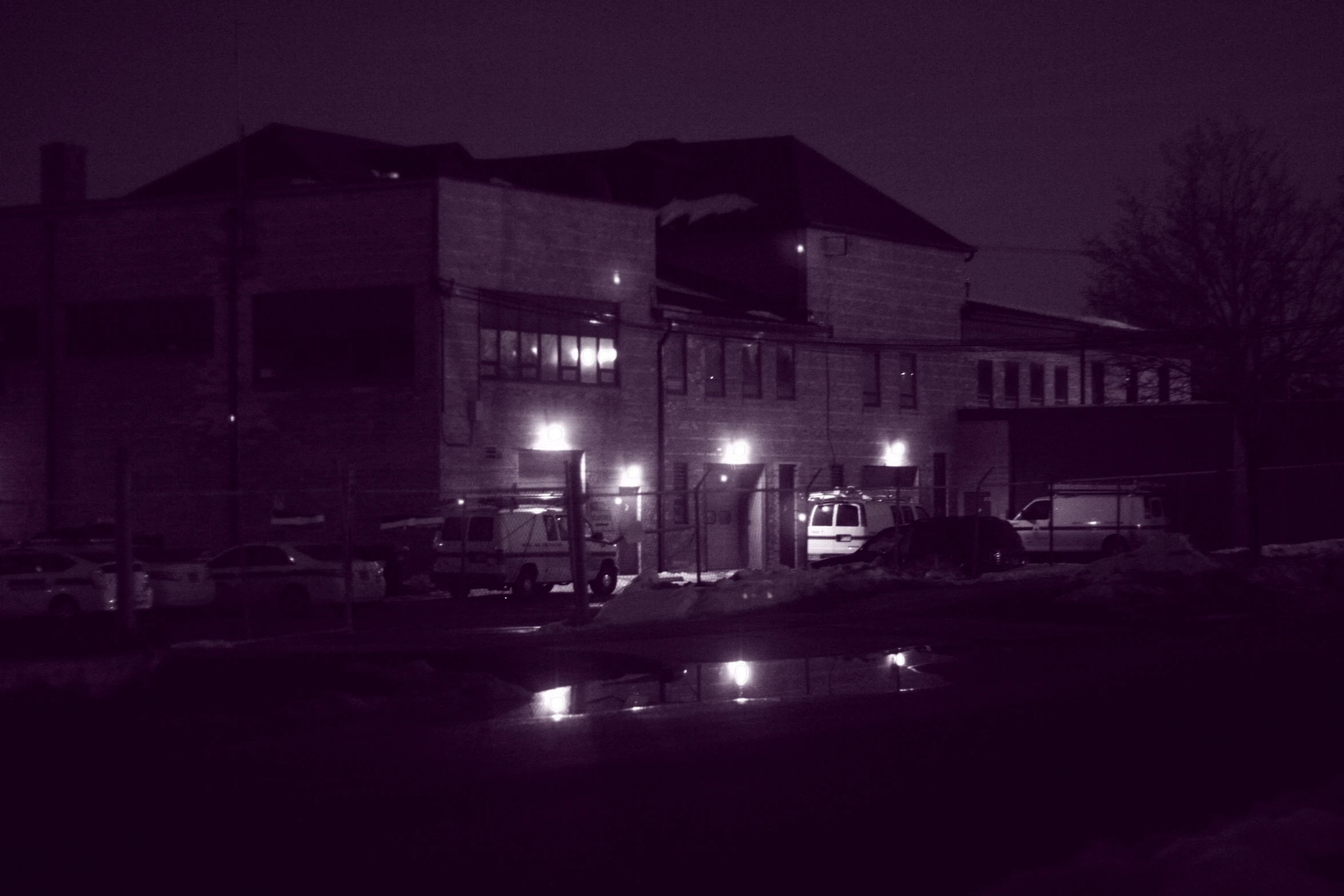 a large building in the dark by a river