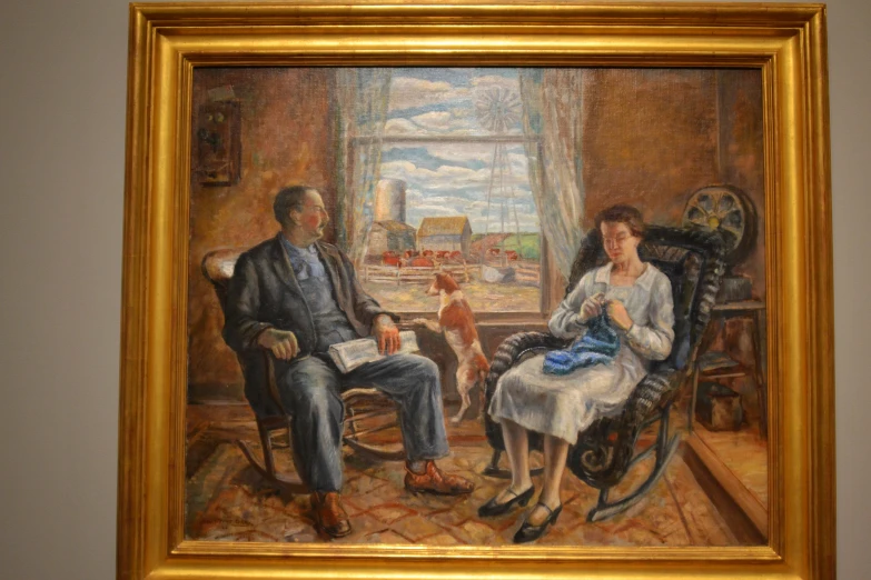 a picture of a man and woman sitting next to each other in front of a dog