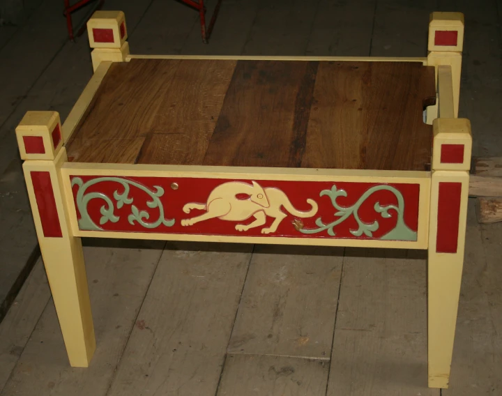 a small table that has an elephant painted on it