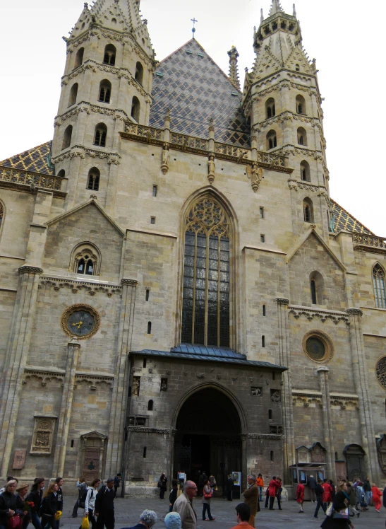 a crowd of people outside of a large building