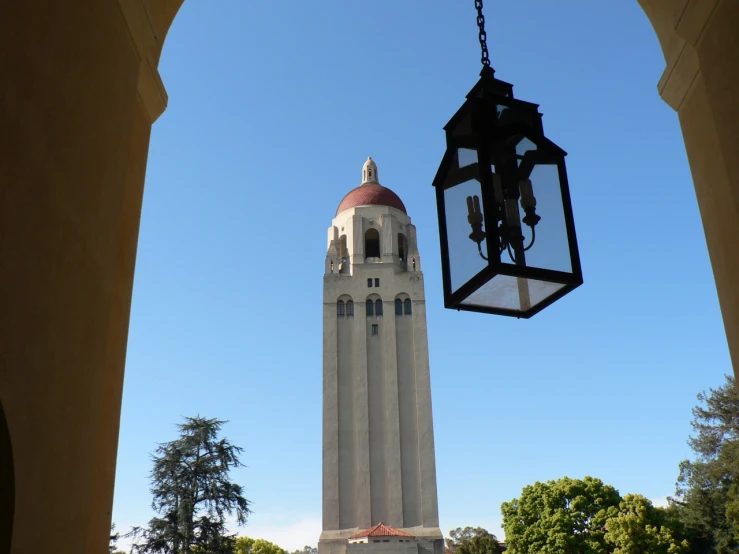 a view through archways of the tower with a lantern hanging